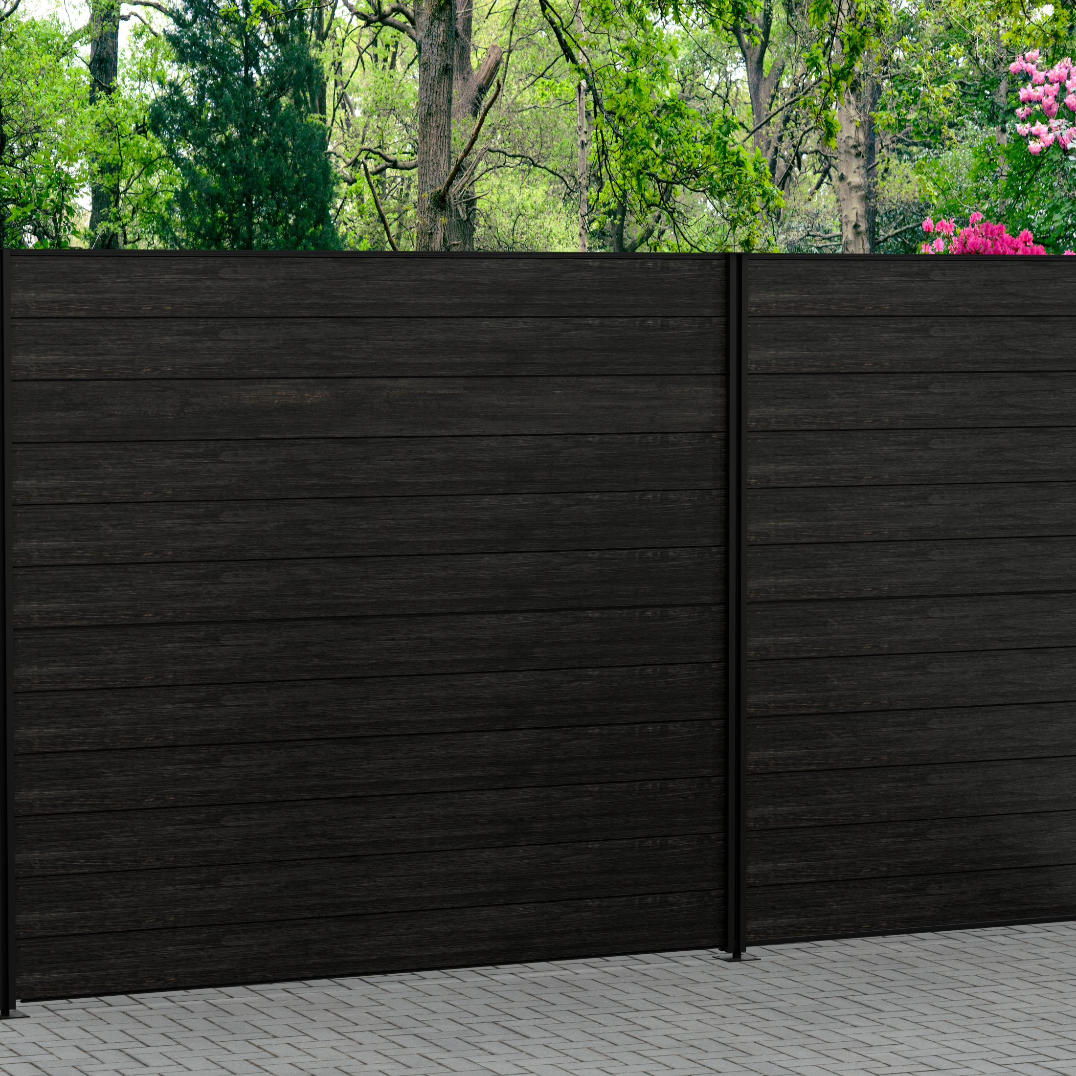 Dark composite fencing panels in a garden